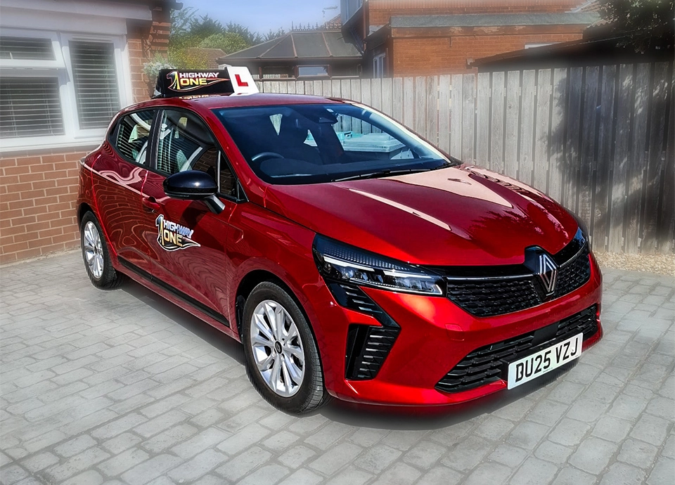 Front left side profile of red Highway One Renault Clio